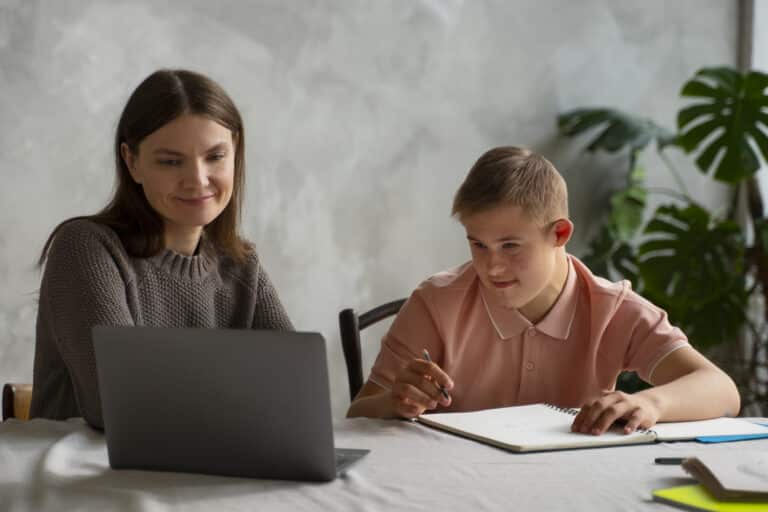 A private tutor giving lesson to a boy in house