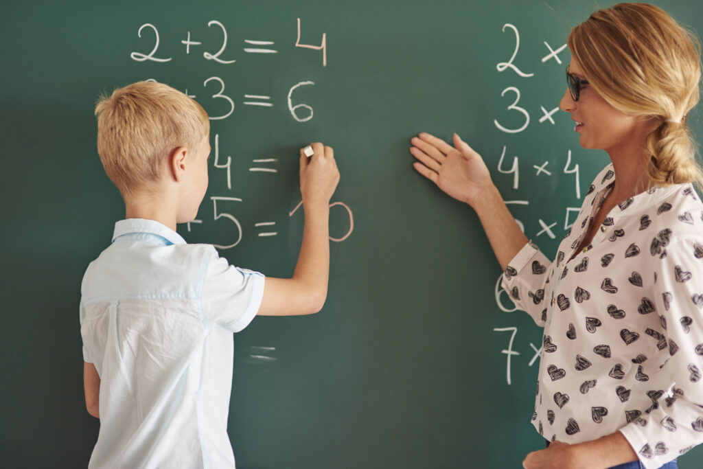 student solving math problem in tuition