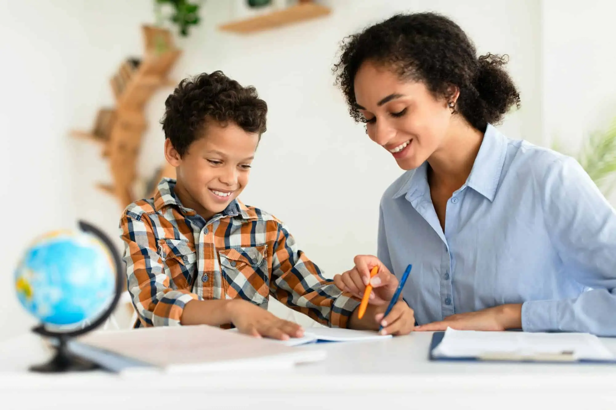 Female tutor providing personalized Arabic lessons to a smiling young student in Dubai.