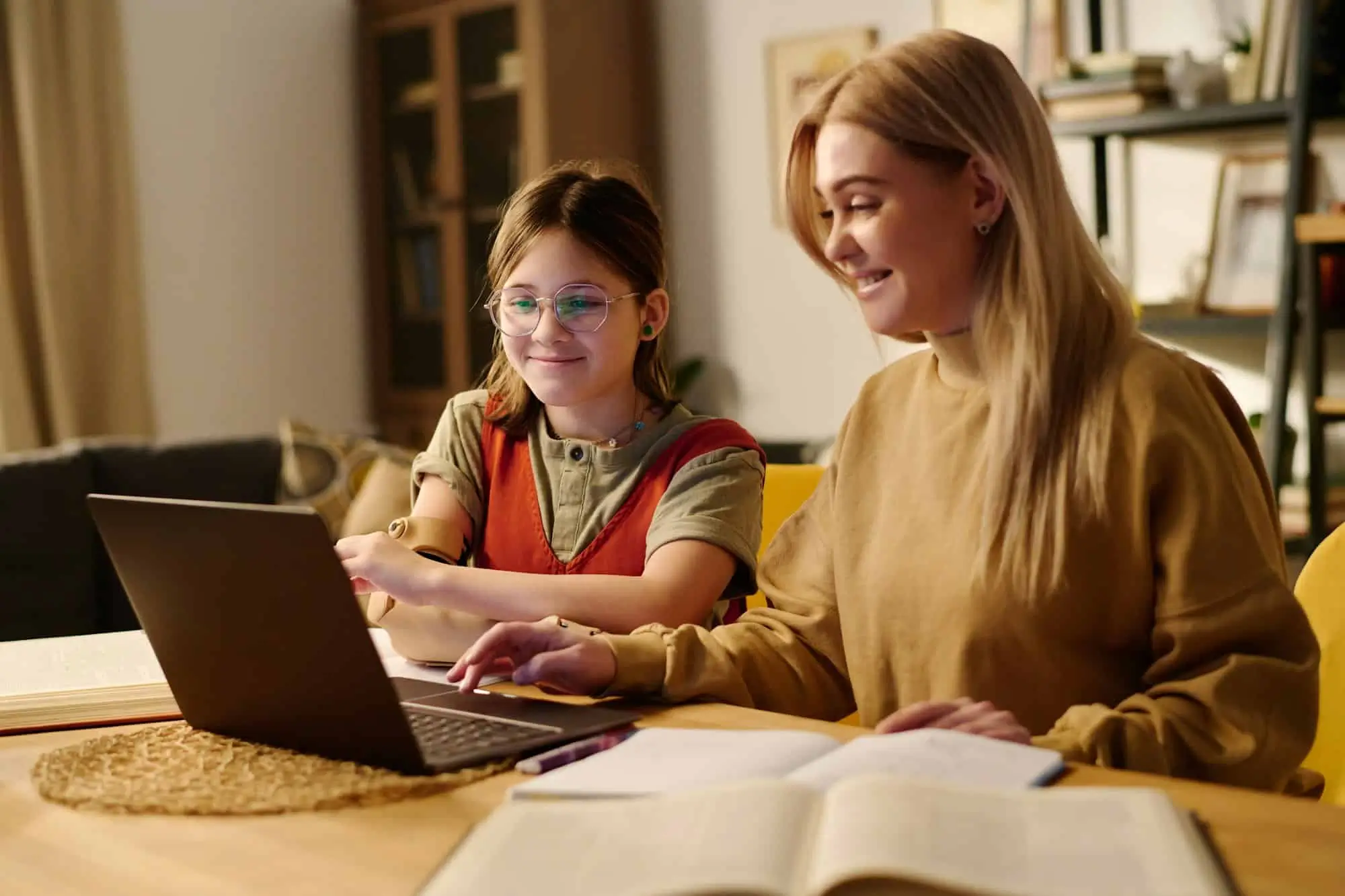Female tutor and student working together on a laptop during a personalized math tutoring session in Dubai.