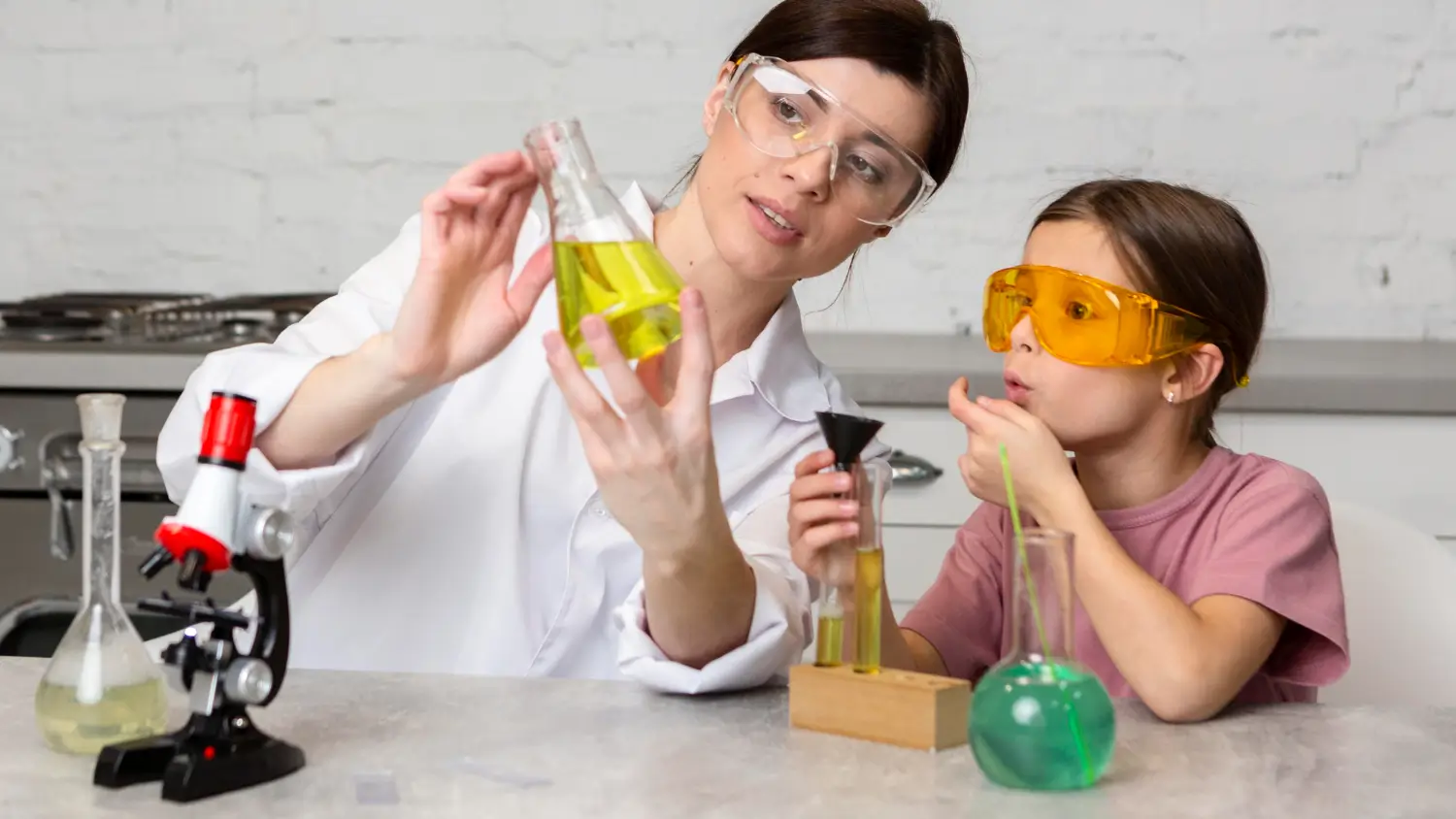 Dubai student and home tutor smiling during a one-on-one IB Chemistry session
