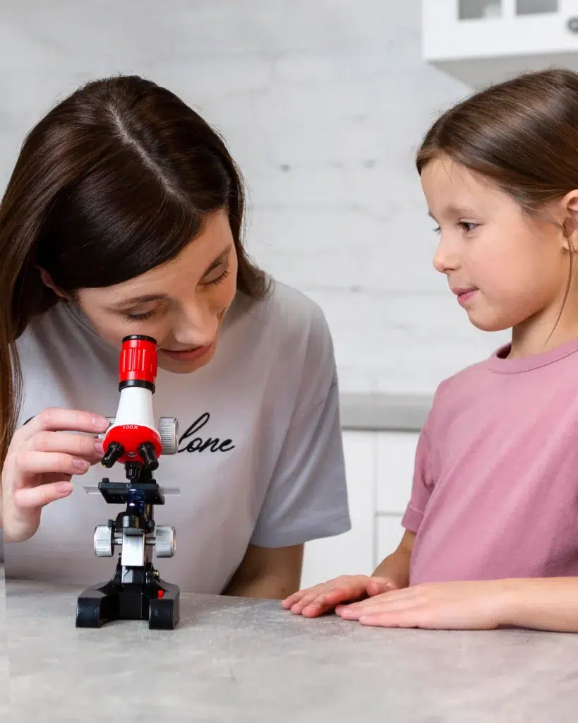 ib chemistry home tutor and girl student doing chemistry experiments with microscope