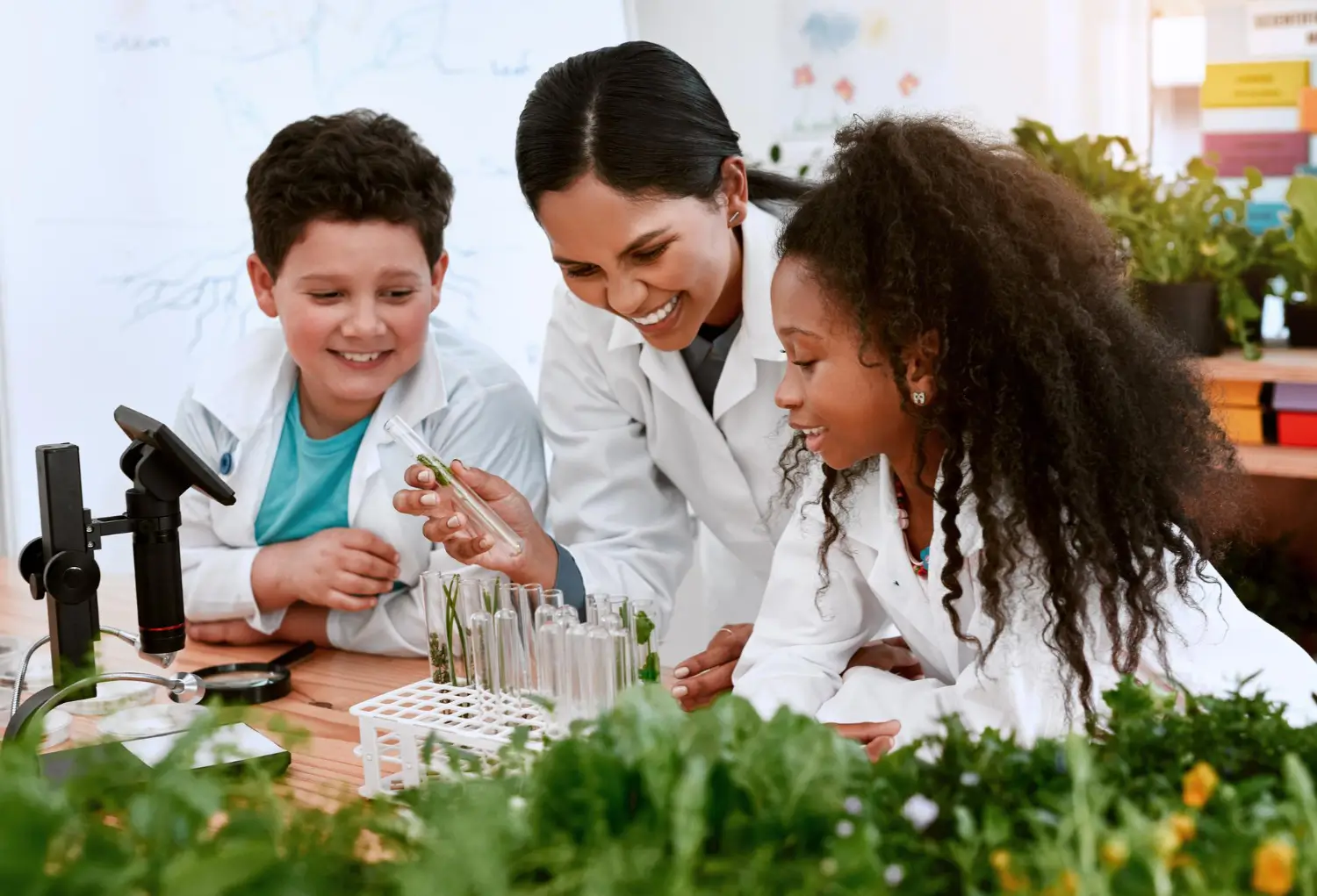 Experienced biology tutor explaining cellular structure to primary school student in modern Dubai