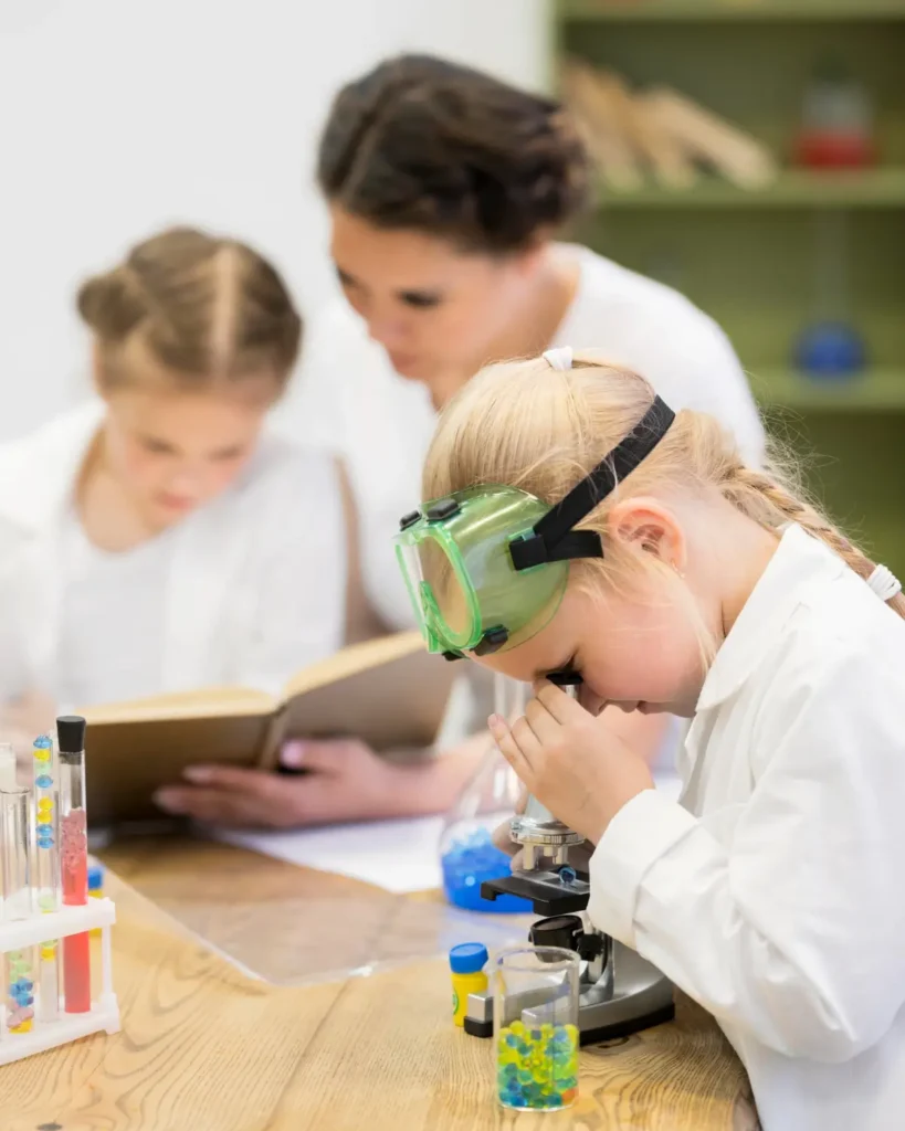 Happy student conducting successful chemistry experiment with Dubai science tutor guidance
